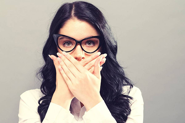 Woman covering her mouth with her hands