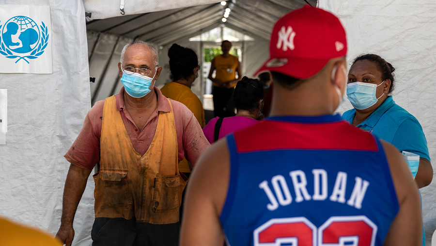 a staff wearing a facemask in the vaccination jab area