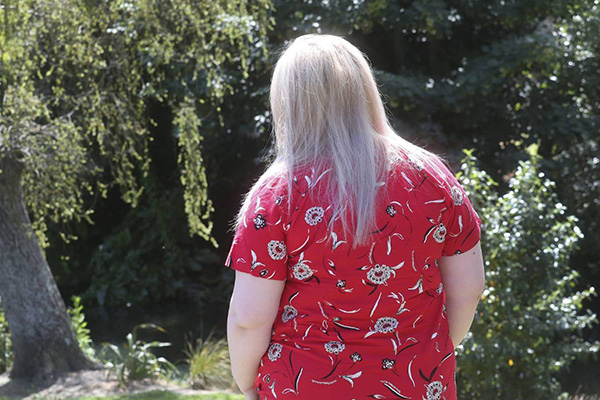 back of woman wearing red dress